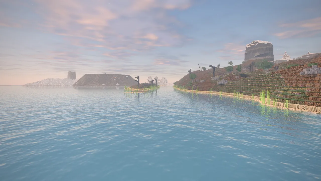 A wide river between low green banks, a mesa in the distance