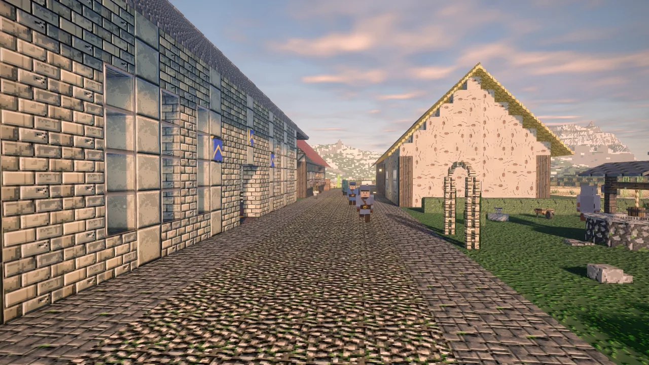 A cobbled street between stone houses, an archway into a garden at its end