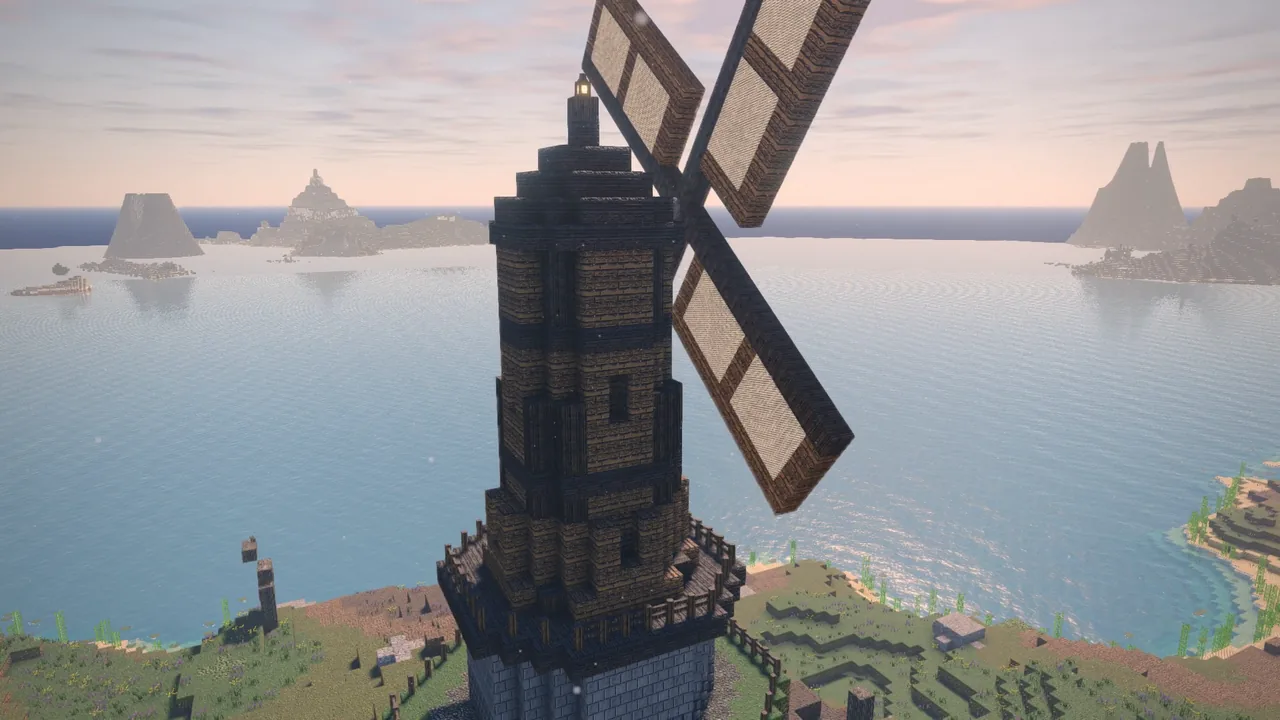 A stone windmill on a headland over the sea